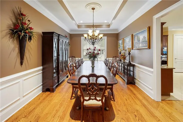 a view of a livingroom with furniture wooden floor and windows