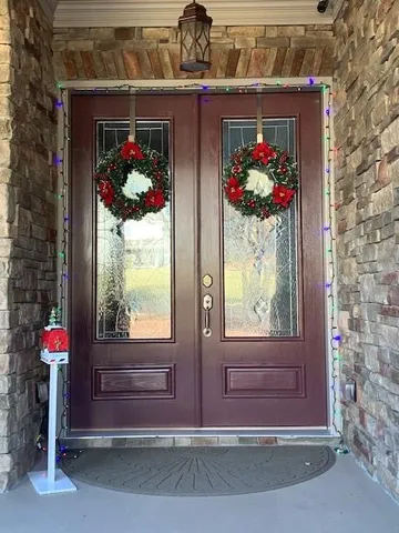a kitchen with stainless steel appliances granite countertop a refrigerator a stove and a sink with wooden cabinets