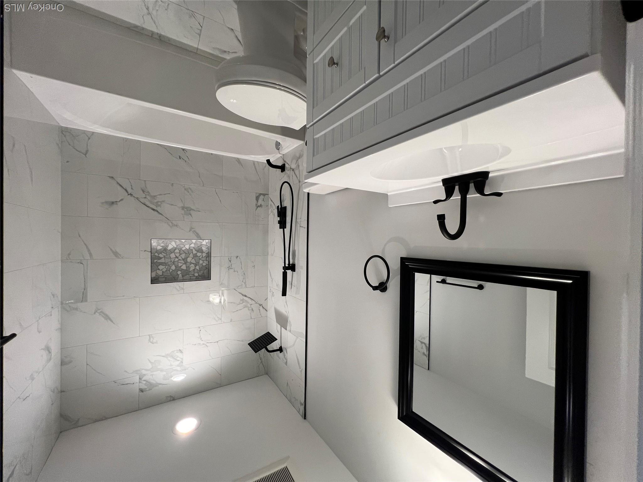 35 Babylon Road Mastic Beach, NY 11951 - Photo 14 of 19 a bathroom with a sink a toilet a mirror and shower