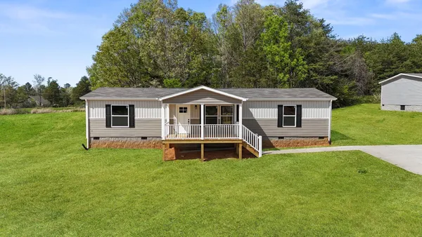 a view of a house with a backyard