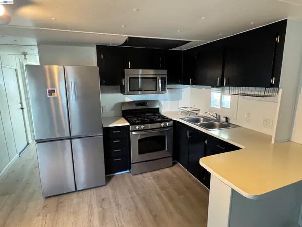a kitchen with stainless steel appliances a stove a microwave and a refrigerator
