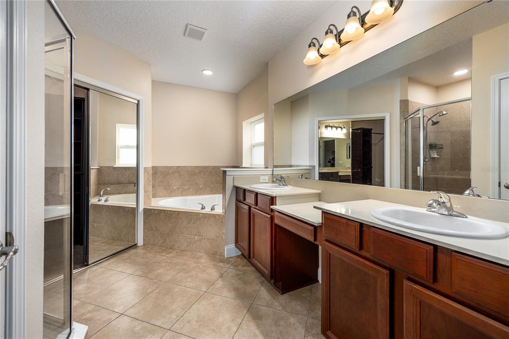 8216 Northwest 54th Street Gainesville, FL 32653 - Photo 37 of 58 a bathroom with a granite countertop sink mirror and double