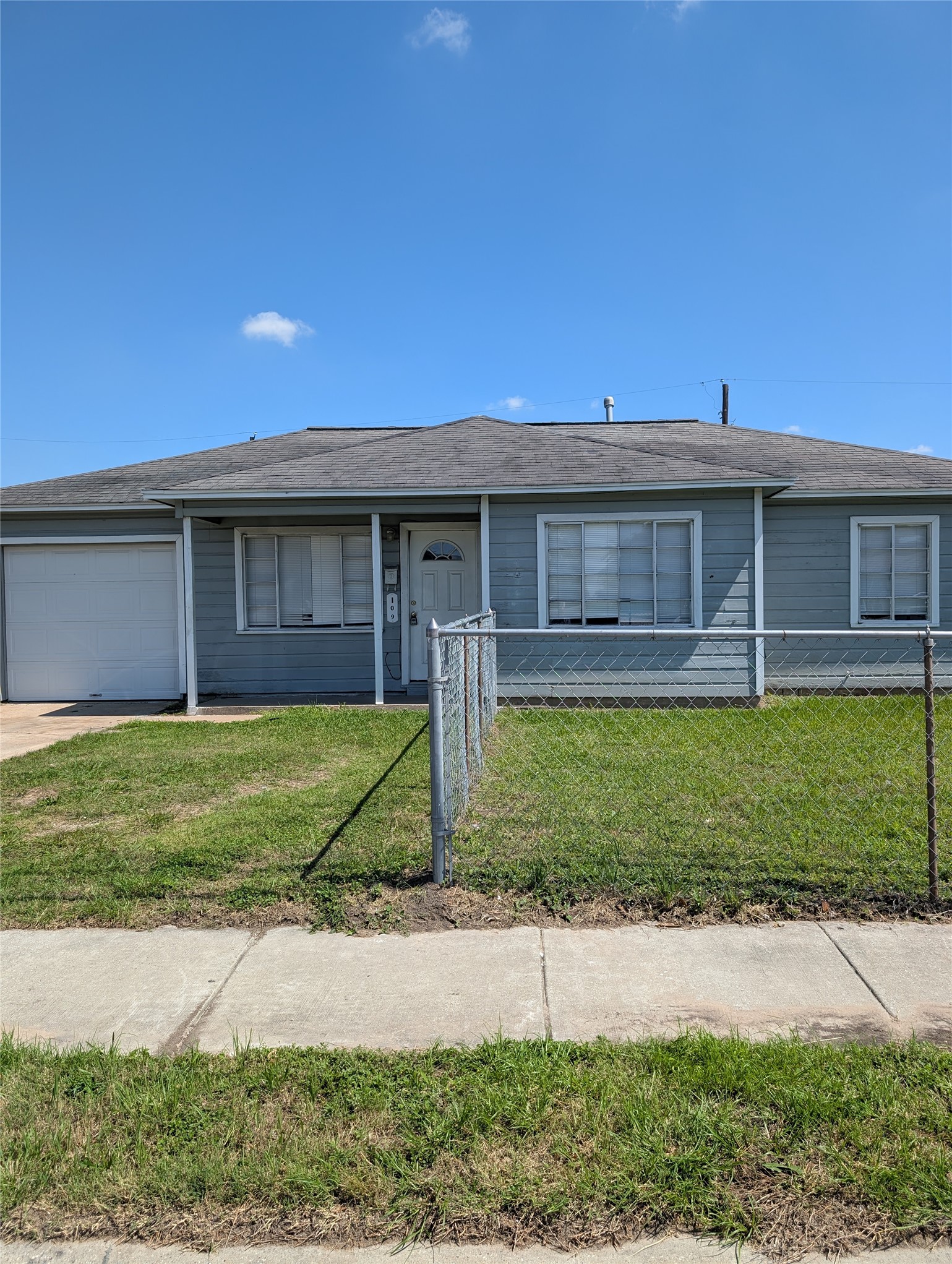 109 East Parker Road Houston, TX 77076 - Photo 1 of 11 a front view of a house with a yard and a garage