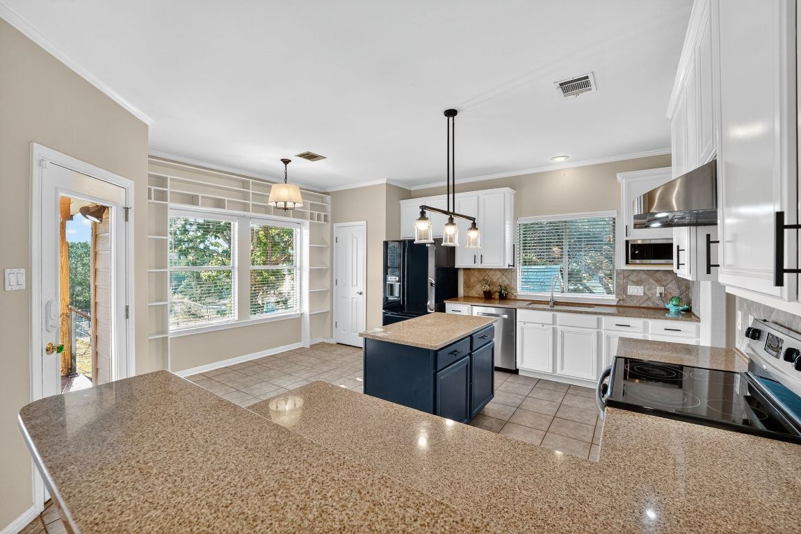 1021 Westland Ridge Road Dripping Springs, TX 78620 - Photo 2 of 31 a open kitchen with cabinets and stainless steel appliances