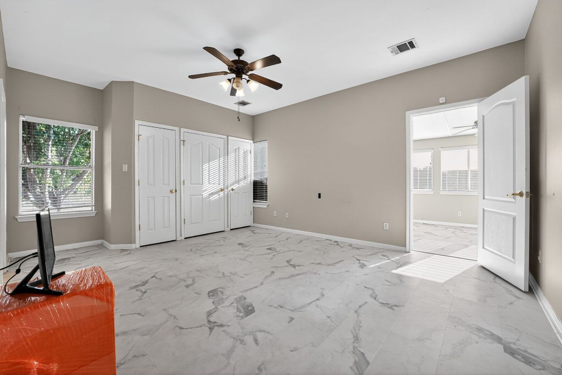 1021 Westland Ridge Road Dripping Springs, TX 78620 - Photo 25 of 31 a view of a livingroom with a chandelier fan and windows