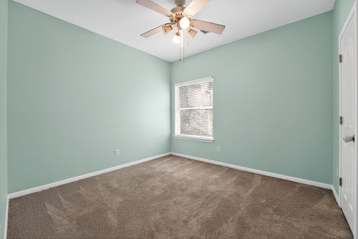 1021 Westland Ridge Road Dripping Springs, TX 78620 - Photo 27 of 31 an empty room with a window and a fan