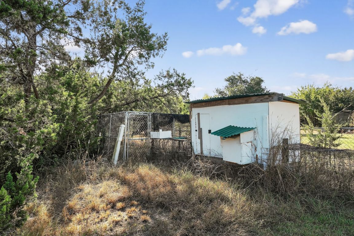 1021 Westland Ridge Road Dripping Springs, TX 78620 - Photo 30 of 31 a backyard of a house with lots of green space