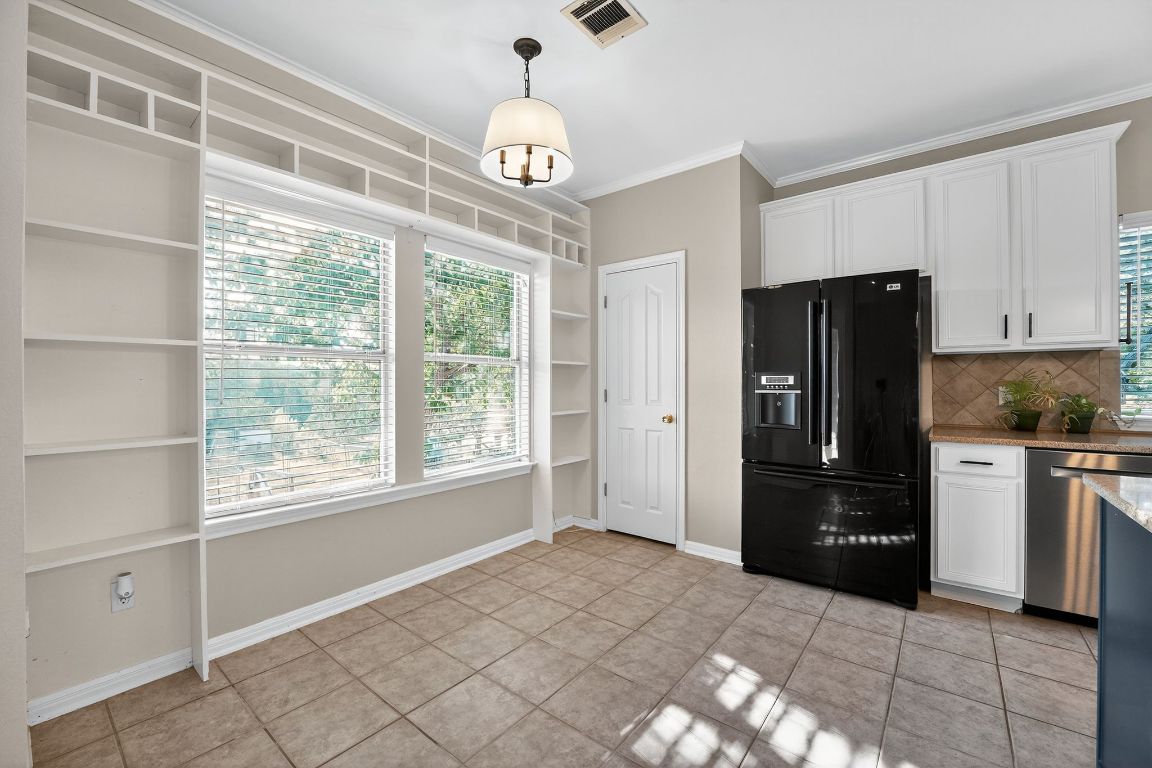 1021 Westland Ridge Road Dripping Springs, TX 78620 - Photo 5 of 31 a kitchen with a refrigerator a stove top oven and kitchen island