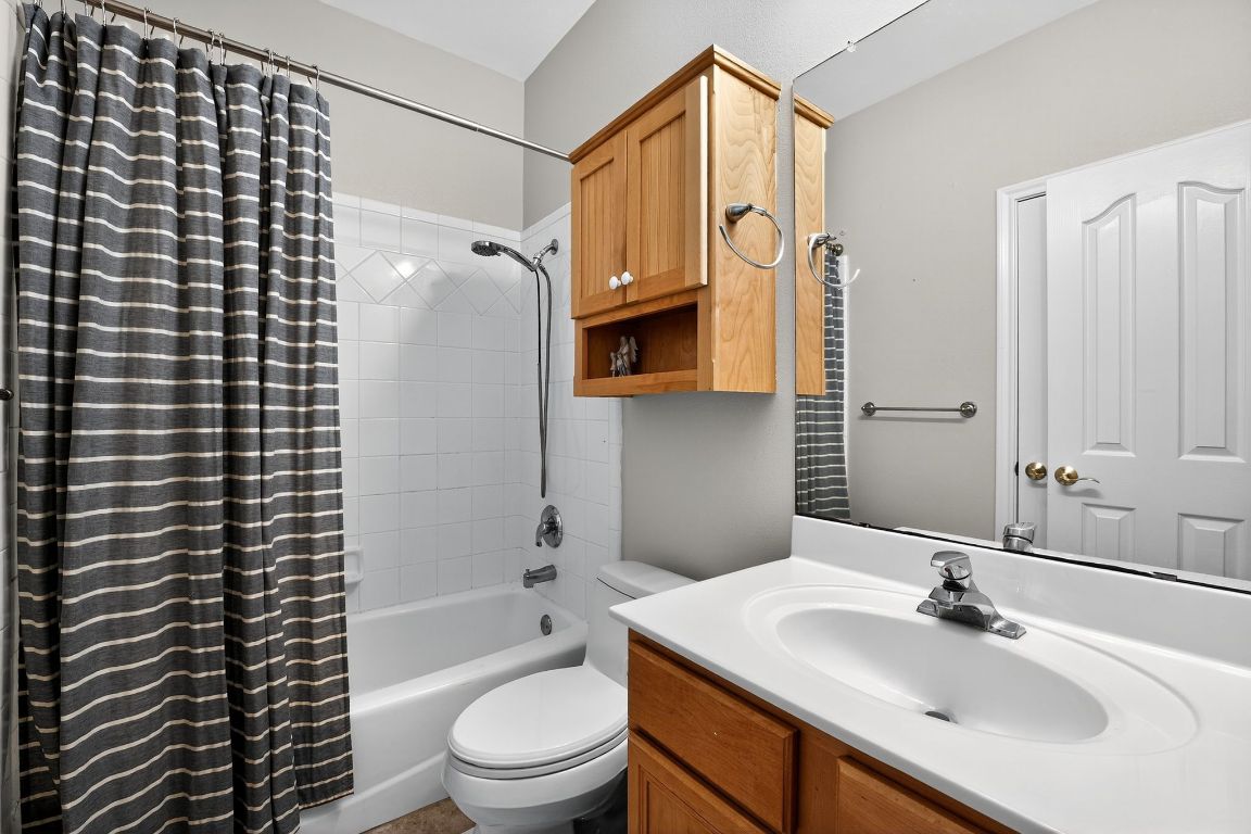 1021 Westland Ridge Road Dripping Springs, TX 78620 - Photo 8 of 31 a bathroom with a sink toilet vanity and shower