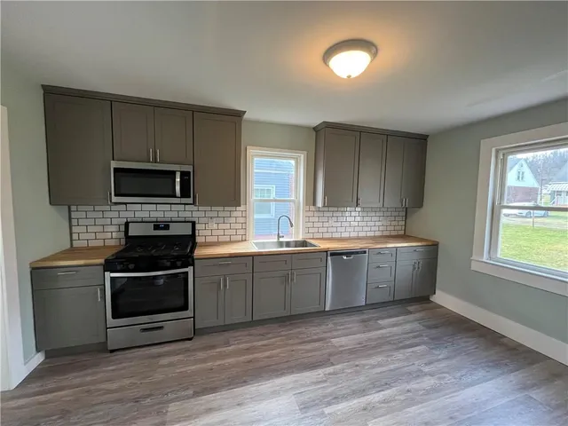 a kitchen with granite countertop a stove top oven and sink