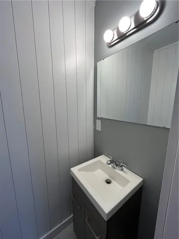 a bathroom with a sink a mirror and a vanity