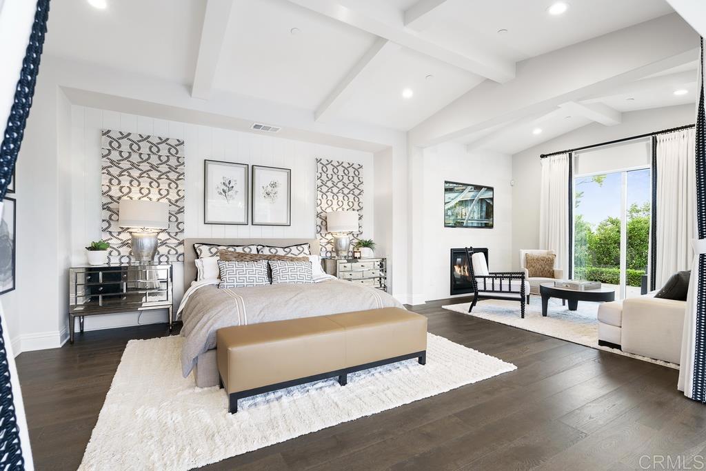 15527 Artesian Ridge San Diego, CA 92127 - Photo 21 of 32 a spacious bedroom with a bed couch and a large window