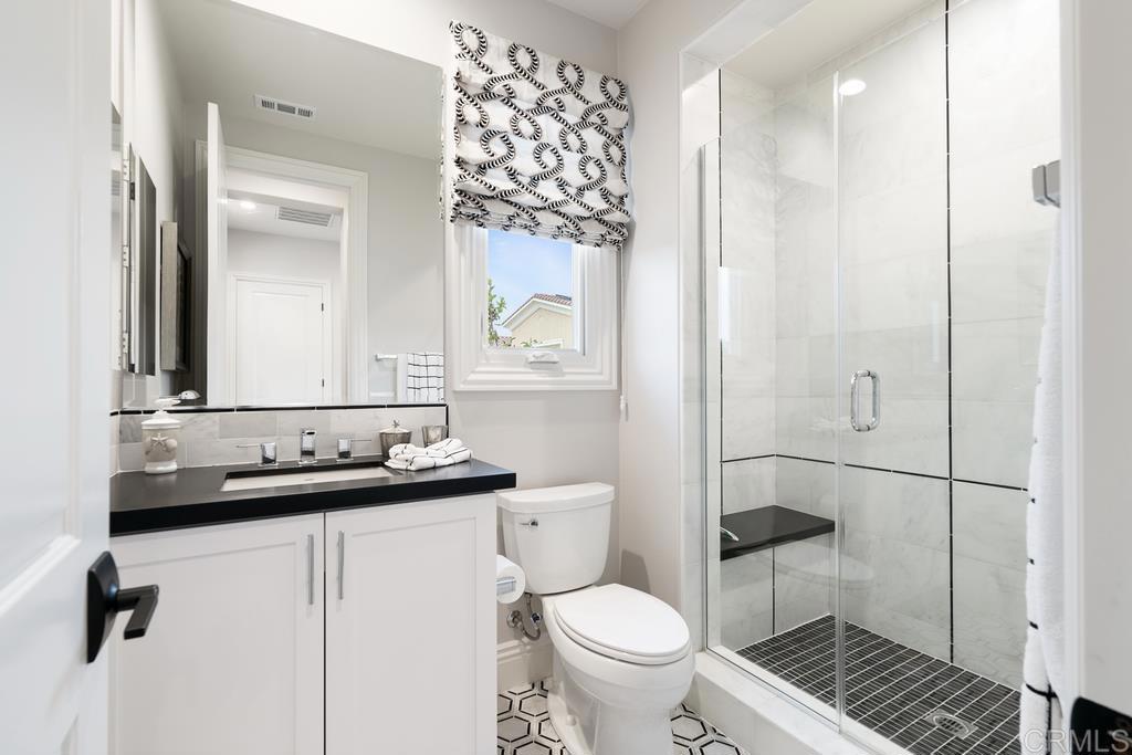 15527 Artesian Ridge San Diego, CA 92127 - Photo 23 of 32 a bathroom with a sink a toilet and shower