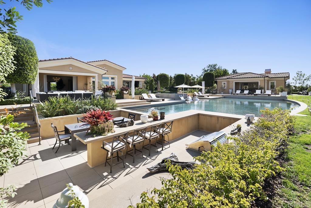 15527 Artesian Ridge San Diego, CA 92127 - Photo 27 of 32 a view of a house with swimming pool and sitting area