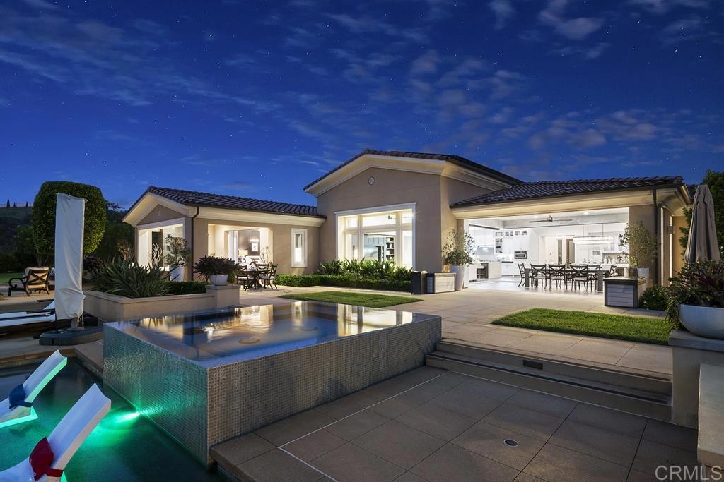 15527 Artesian Ridge San Diego, CA 92127 - Photo 28 of 32 a living room with furniture a dining table and a potted plant
