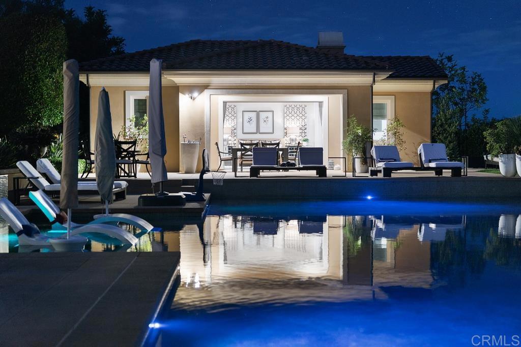 15527 Artesian Ridge San Diego, CA 92127 - Photo 30 of 32 a living room with furniture and a floor to ceiling window