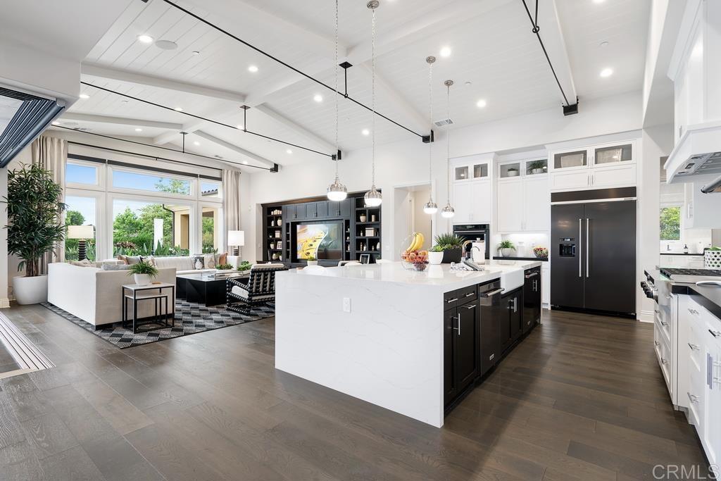 15527 Artesian Ridge San Diego, CA 92127 - Photo 5 of 32 a kitchen with stainless steel appliances kitchen island wooden cabinets and a refrigerator