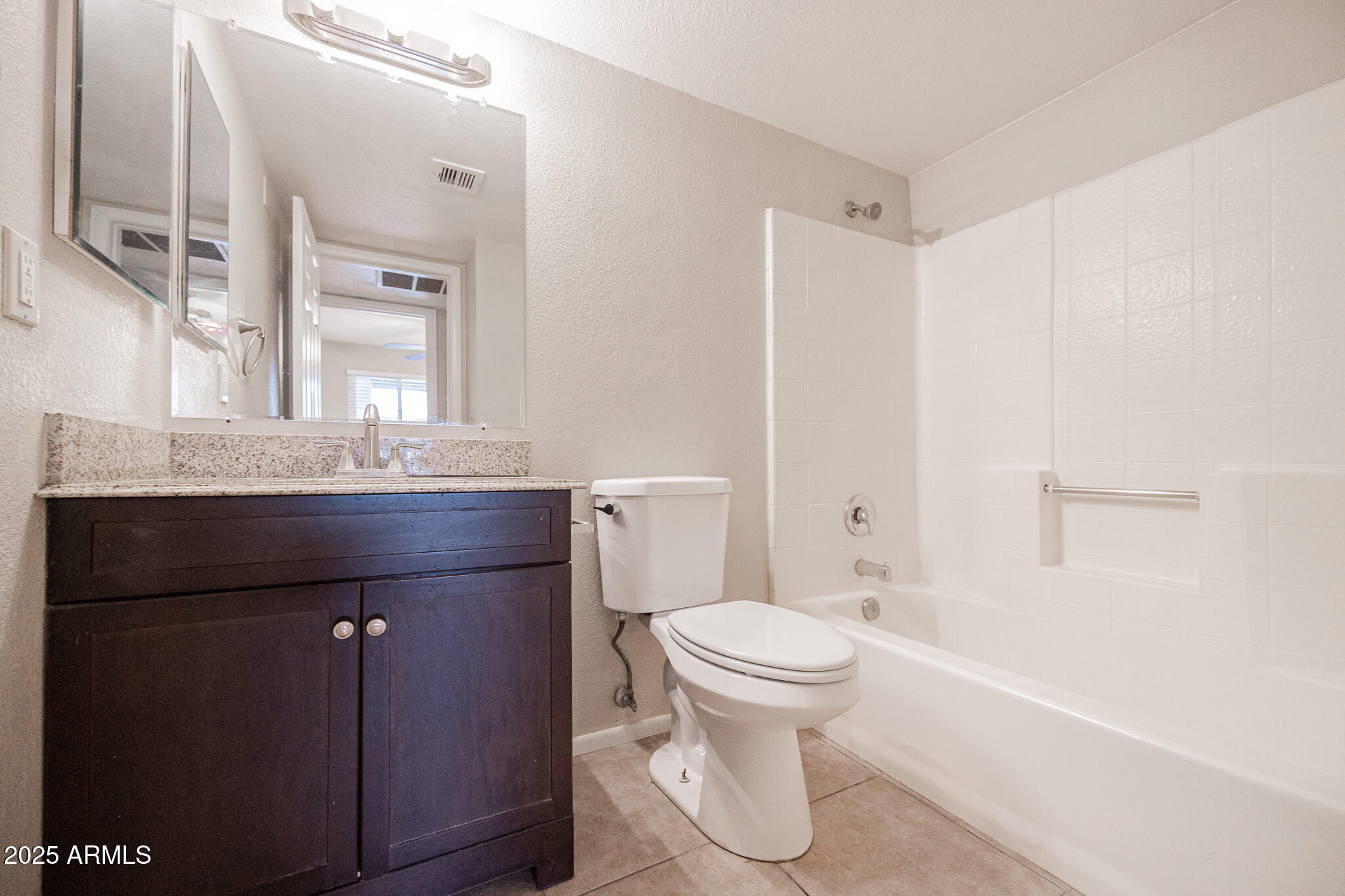 2127 East 10th Street, Unit 4 Tempe, AZ 85281 - Photo 14 of 21 a bathroom with a granite countertop sink a toilet and a bathtub