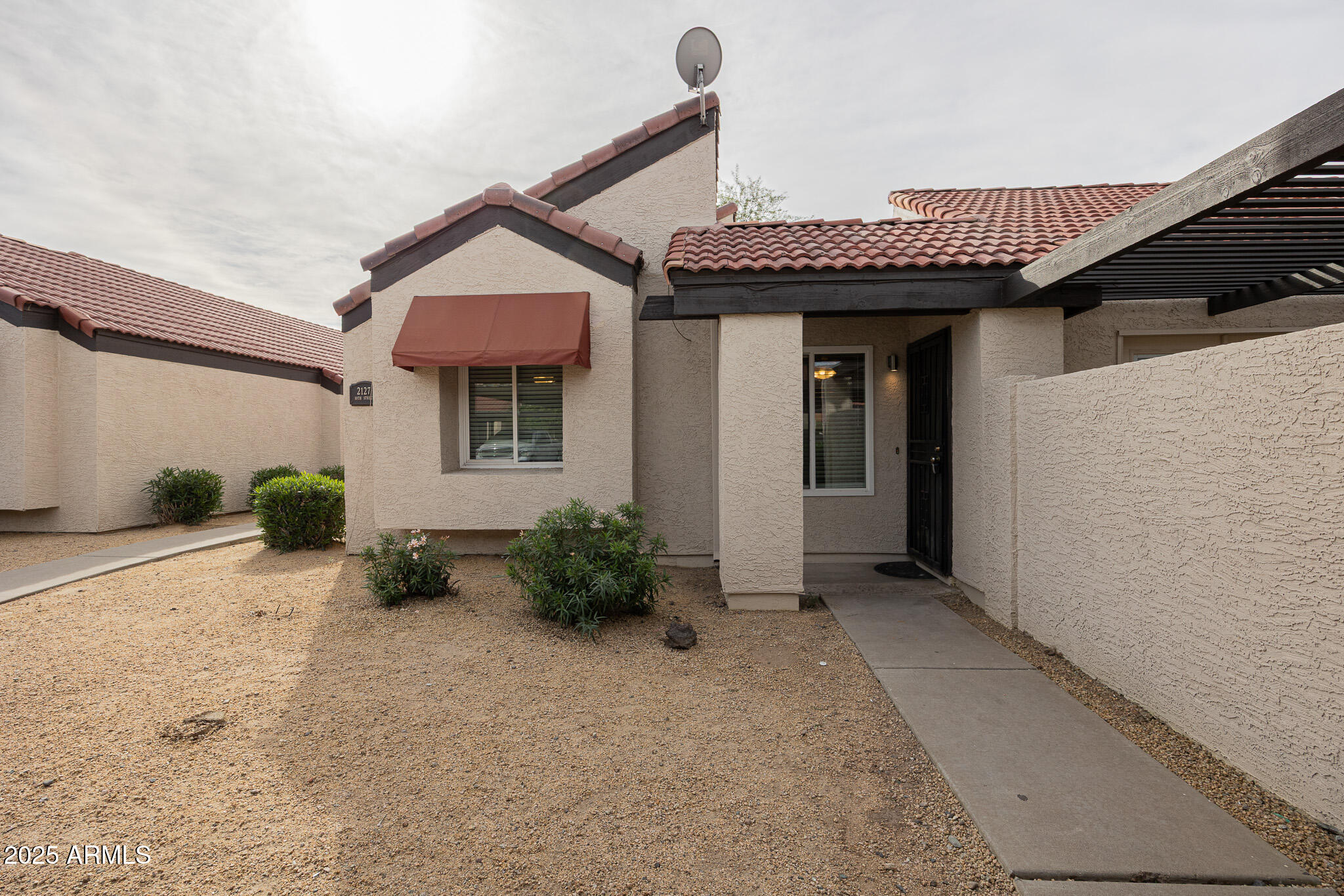 2127 East 10th Street, Unit 4 Tempe, AZ 85281 - Photo 2 of 21 a view of a house with plants and wooden fence
