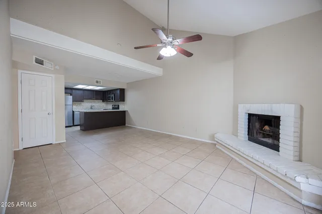 a view of empty room with fireplace