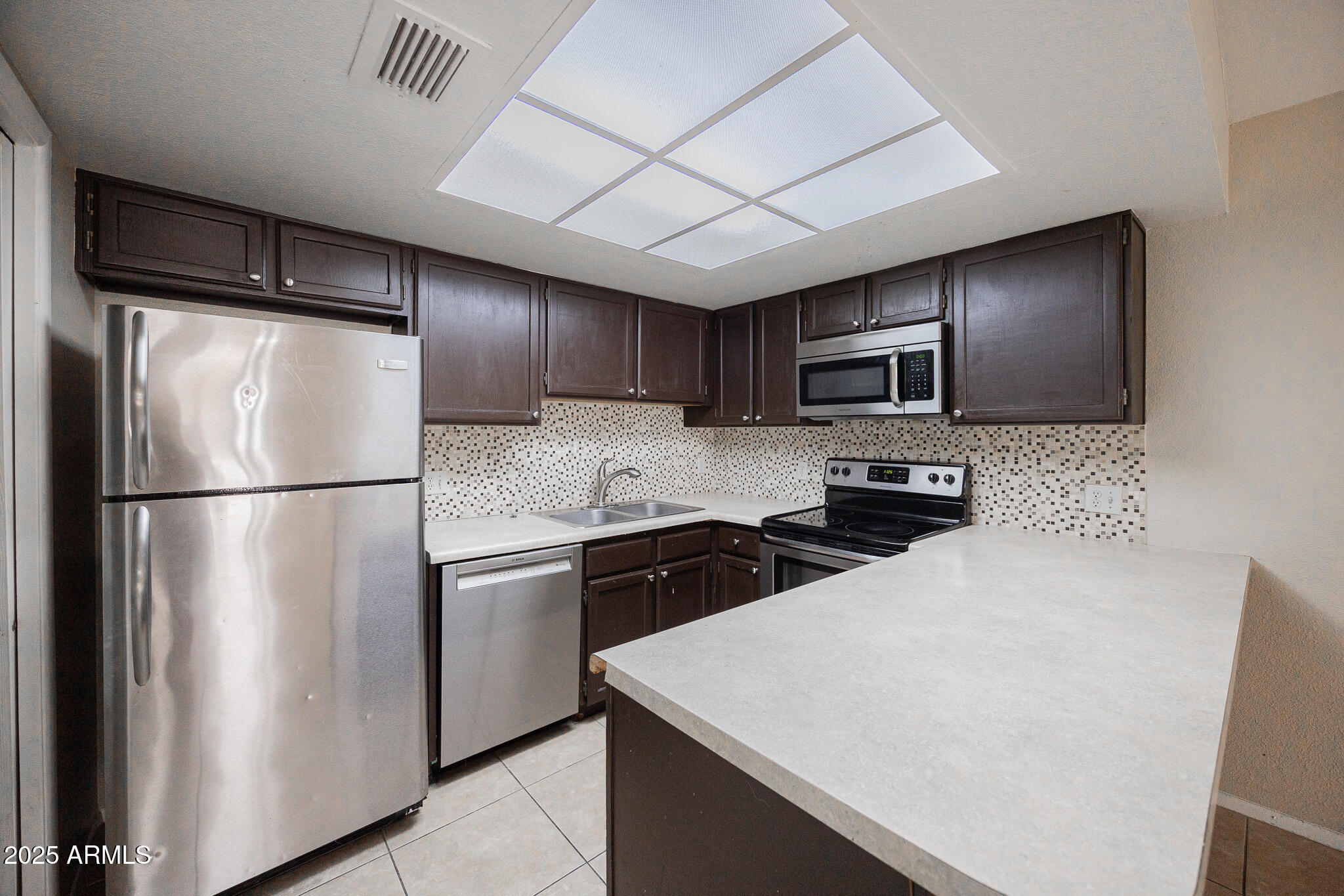 2127 East 10th Street, Unit 4 Tempe, AZ 85281 - Photo 8 of 21 a kitchen with stainless steel appliances granite countertop a refrigerator a stove a sink dishwasher and a refrigerator with wooden floor