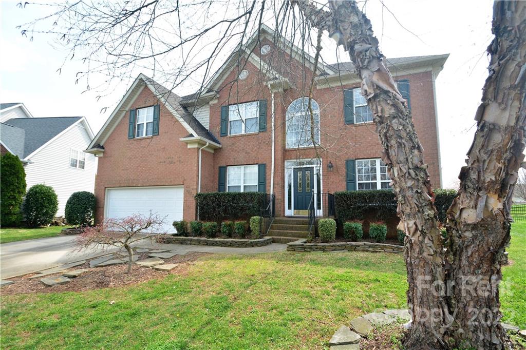 a view of house with yard and outdoor seating