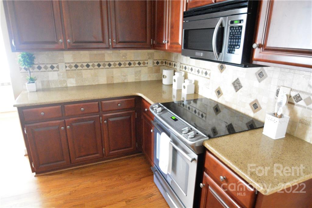 2127 Copperplate Road Charlotte, NC 28262 - Photo 13 of 37 a kitchen with stainless steel appliances granite countertop a sink and cabinets