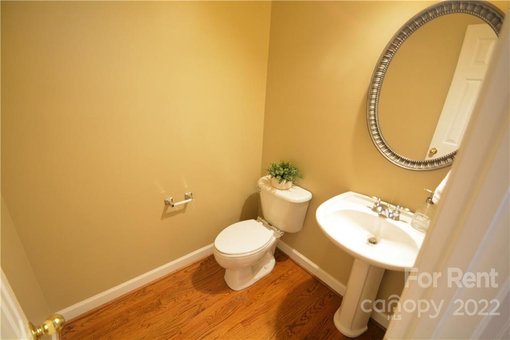 2127 Copperplate Road Charlotte, NC 28262 - Photo 21 of 37 a bathroom with a sink and a mirror
