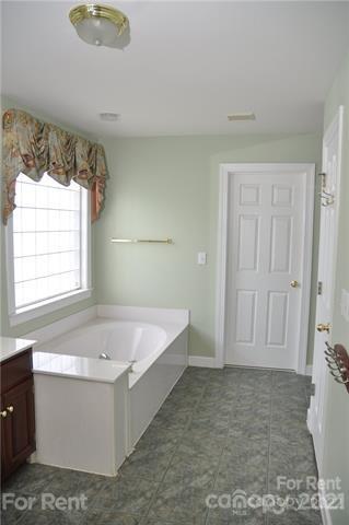 2127 Copperplate Road Charlotte, NC 28262 - Photo 26 of 37 a bathroom with a bathtub and shower