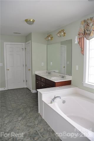 2127 Copperplate Road Charlotte, NC 28262 - Photo 27 of 37 a bathroom with a bathtub and a sink