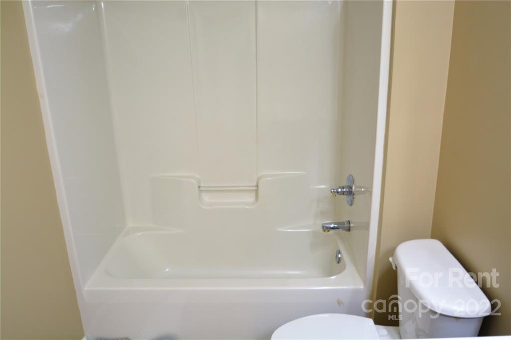 2127 Copperplate Road Charlotte, NC 28262 - Photo 30 of 37 a bathroom with a bathtub and toilet