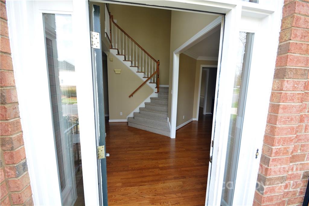 2127 Copperplate Road Charlotte, NC 28262 - Photo 3 of 37 a view of a hallway with wooden floor and staircase