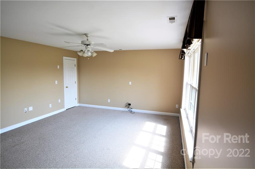 2127 Copperplate Road Charlotte, NC 28262 - Photo 31 of 37 wooden floor in an empty room with a window