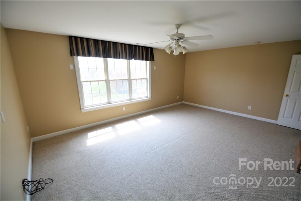 2127 Copperplate Road Charlotte, NC 28262 - Photo 32 of 37 an empty room with a window