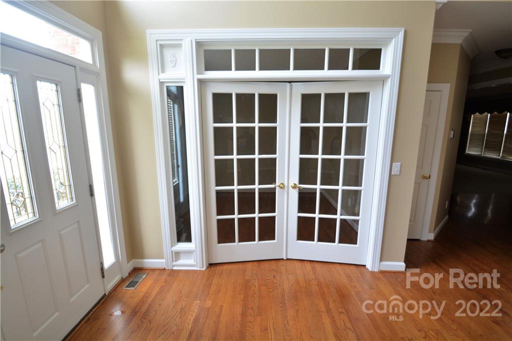 2127 Copperplate Road Charlotte, NC 28262 - Photo 7 of 37 a view of front door with wooden floor and windows