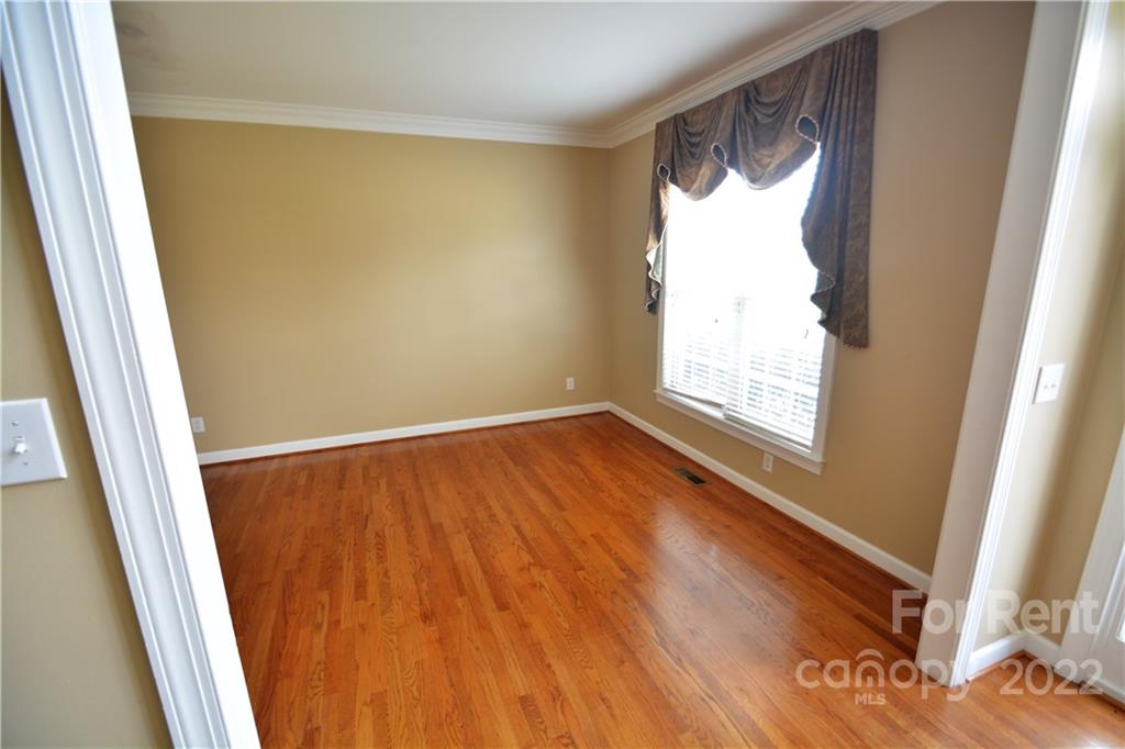 2127 Copperplate Road Charlotte, NC 28262 - Photo 10 of 37 a view of an empty room with wooden floor and a window