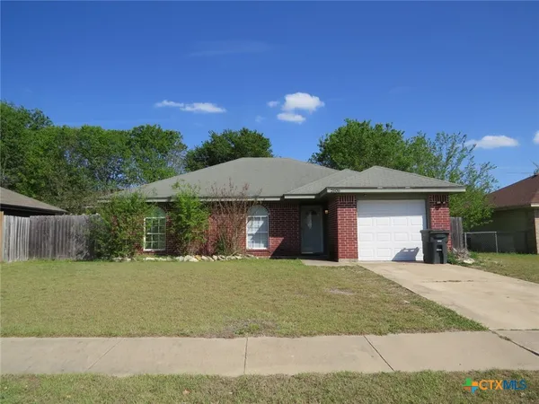 a view of a house with a yard and garage