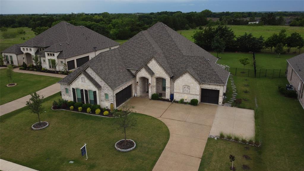 an aerial view of a house with yard