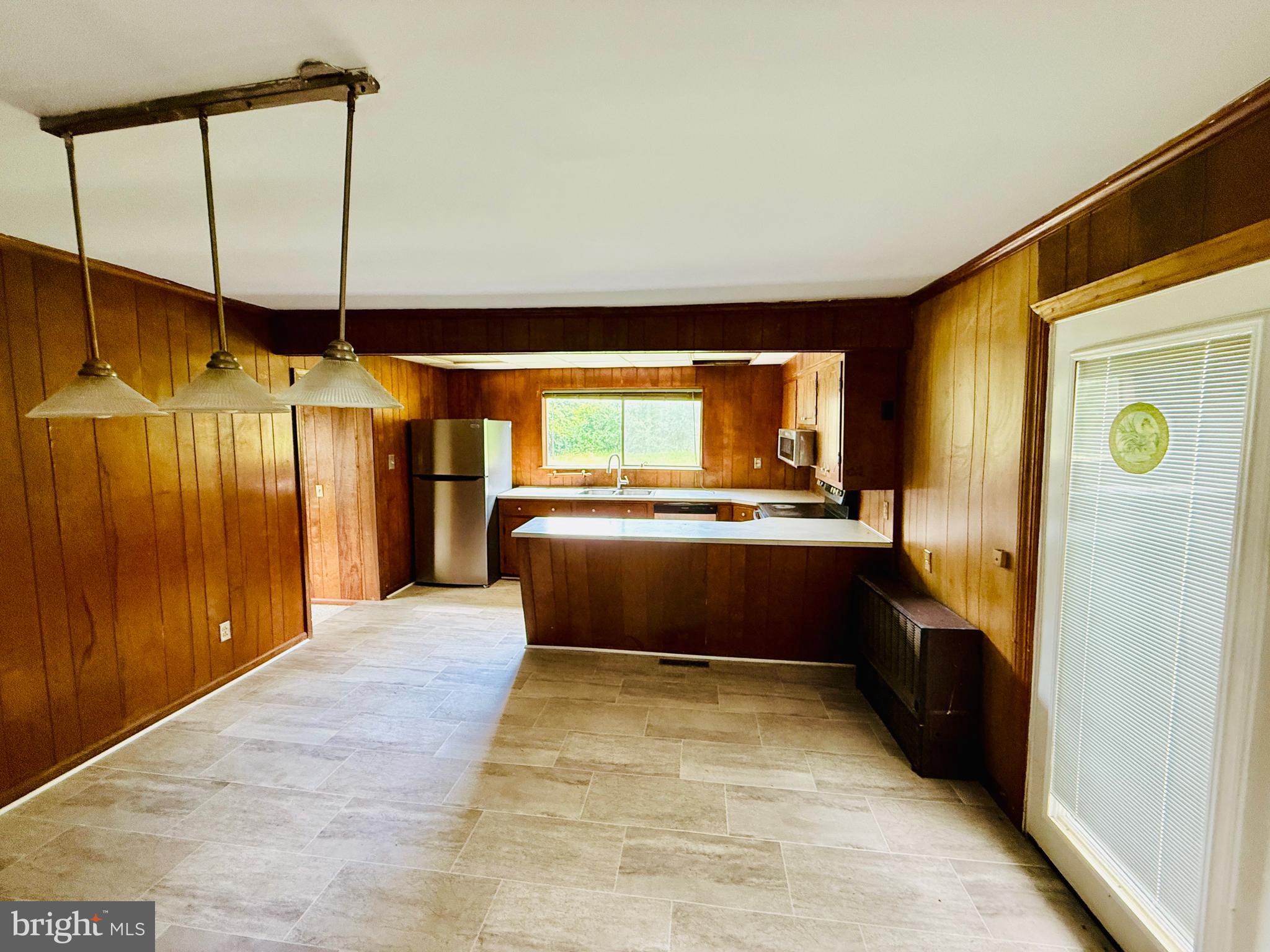 1031 MacDonald Road Scottsburg, VA 24589 - Photo 17 of 43 a kitchen with stainless steel appliances kitchen island granite countertop a refrigerator and a sink