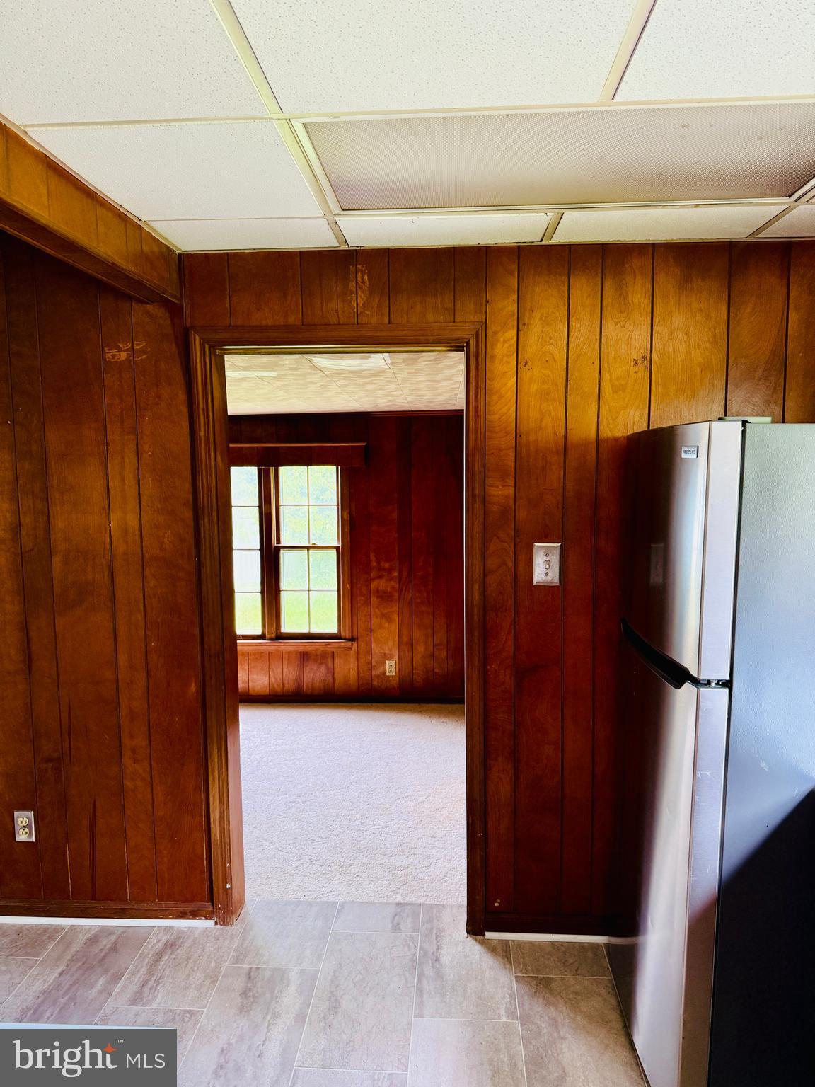 1031 MacDonald Road Scottsburg, VA 24589 - Photo 19 of 43 a view of a refrigerator in kitchen and a glass door