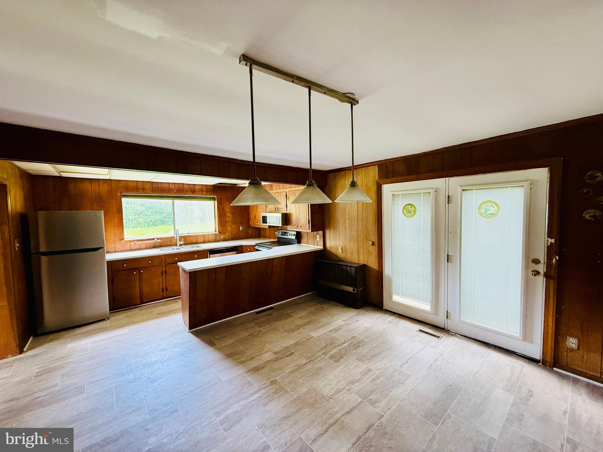 1031 MacDonald Road Scottsburg, VA 24589 - Photo 35 of 43 a kitchen with stainless steel appliances kitchen island granite countertop a refrigerator and a stove