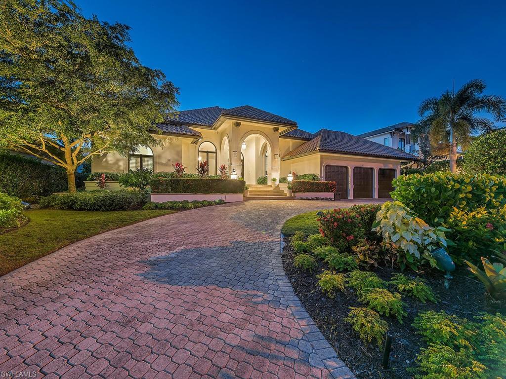 4217 Crayton Road Naples, FL 34103 - Photo 1 of 22 a front view of a house with a yard