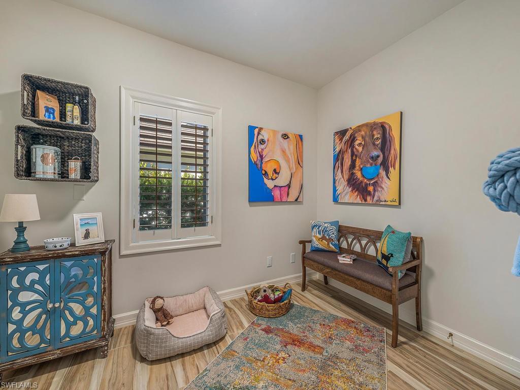4217 Crayton Road Naples, FL 34103 - Photo 16 of 22 a living room with furniture and a book shelf