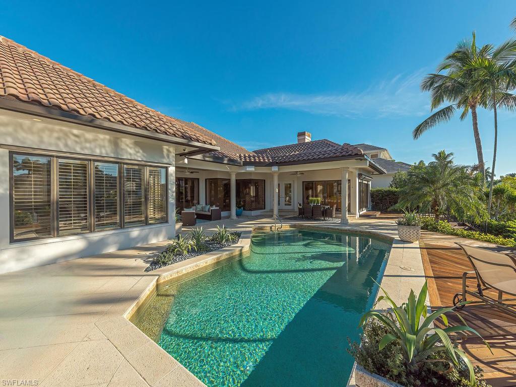 4217 Crayton Road Naples, FL 34103 - Photo 17 of 22 a view of a house with backyard sitting area and swimming pool