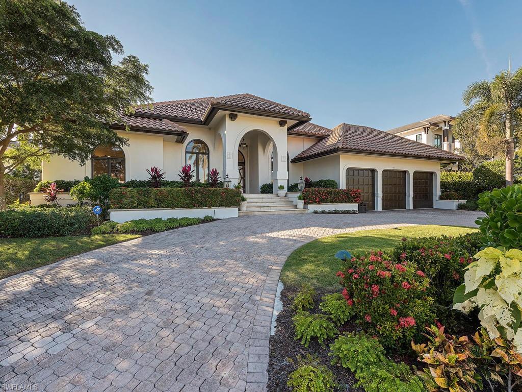 4217 Crayton Road Naples, FL 34103 - Photo 21 of 22 a front view of a house with garden