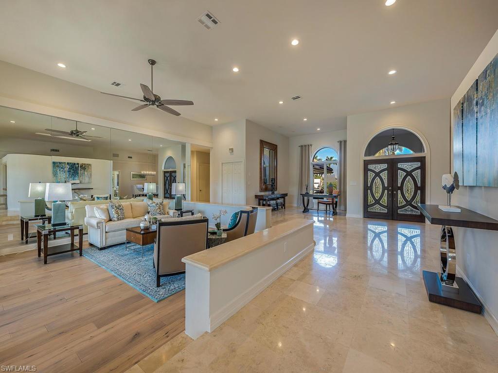 4217 Crayton Road Naples, FL 34103 - Photo 3 of 22 a living room with furniture and a wooden floor