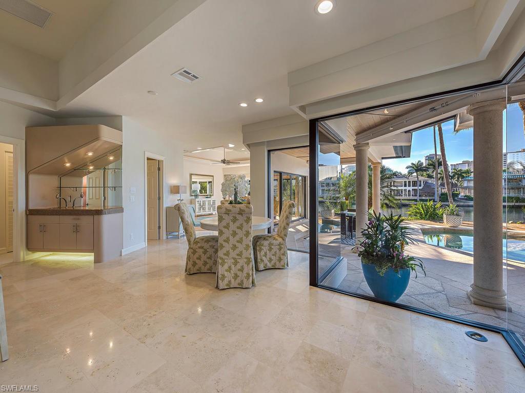 4217 Crayton Road Naples, FL 34103 - Photo 8 of 22 a view of a furniture and floor to ceiling window