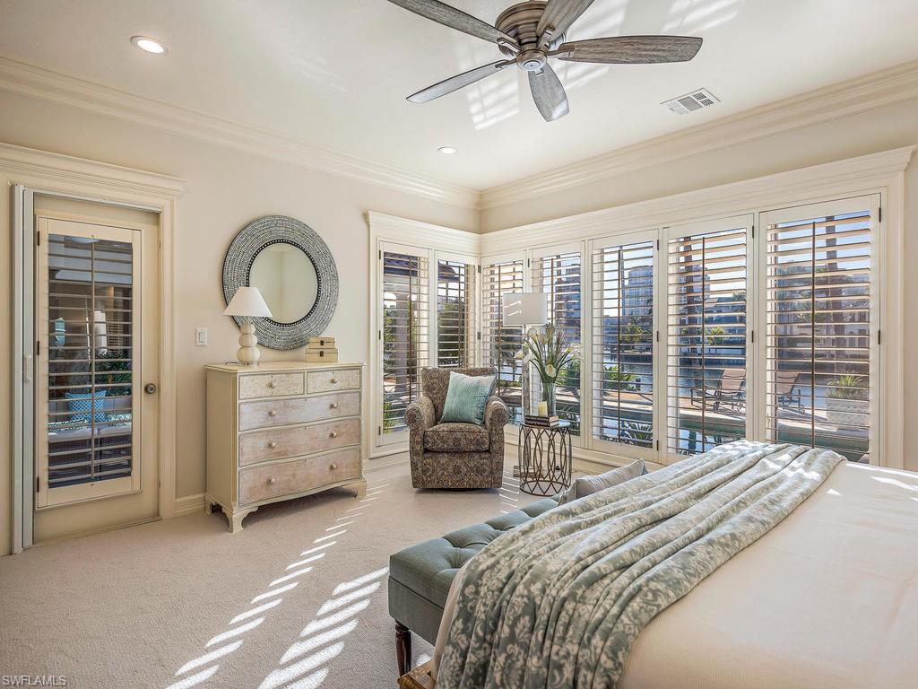 4217 Crayton Road Naples, FL 34103 - Photo 10 of 22 a bedroom with a bed a couch and large window