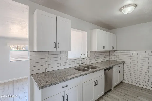 a kitchen with a sink dishwasher and cabinets