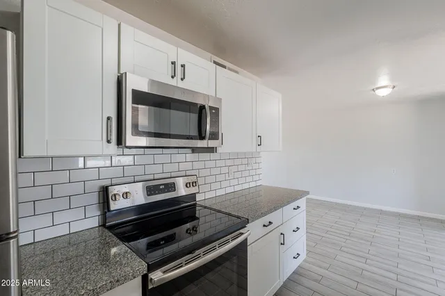 a kitchen with a stove and a microwave